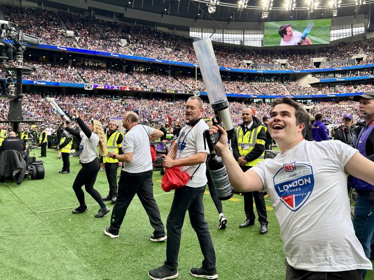 Team of brand ambassadors use T-shirt launchers to fire promotional T-shirts into the crowd at a packed stadium for London NFL Series